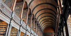 A huge old wooden library with many bookshelves